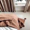 beige camel pompom blanket